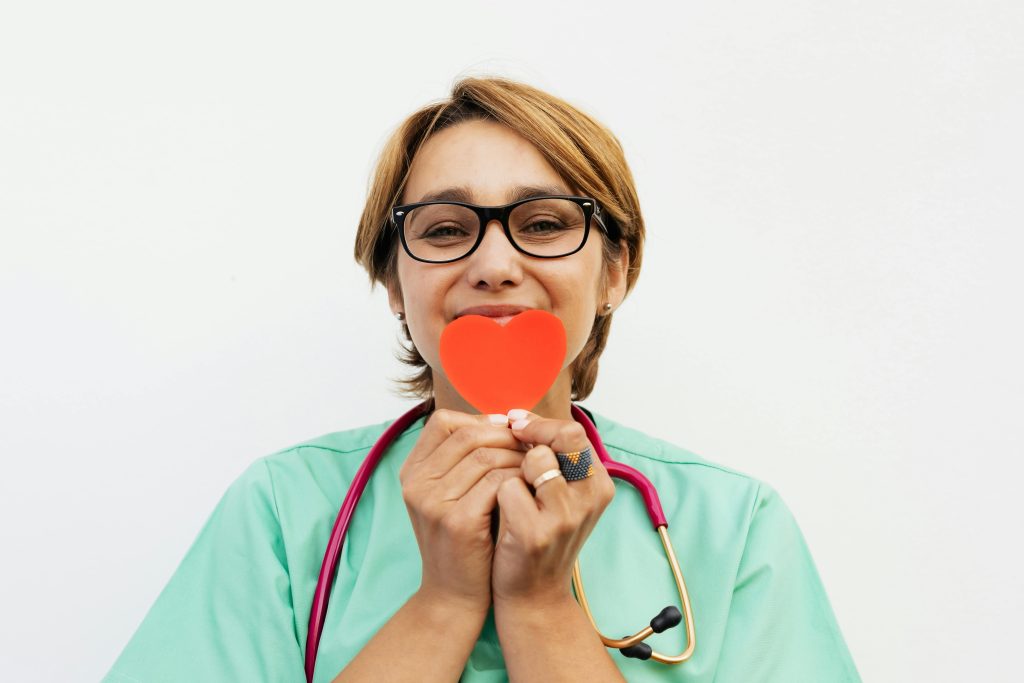 pexels photo 5207096 5207096 Doctor holding a red heart symbol, promoting healthcare compassion.